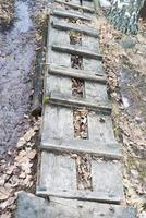 Wooden ladder lying on the ground. photo