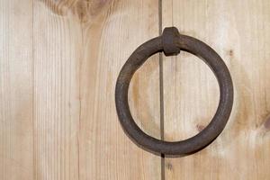 A wooden door with a ring.