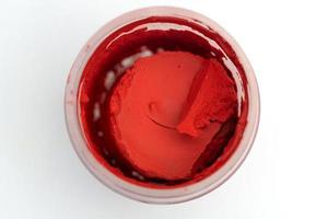 Top view of the jar of red paint. photo