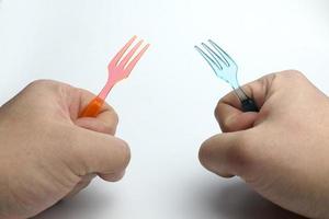 Hand holding a plastic fork. photo