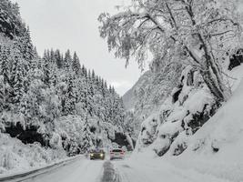 Driving through snowy road and landscape in Norway. photo