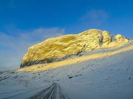 Driving at sunrise through mountains and forests in Norway. photo