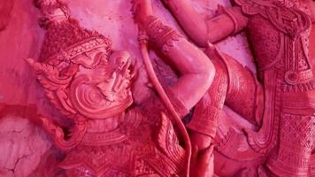 Fighting wall figures sculptures Wat Sila Ngu red temple, Thailand. video