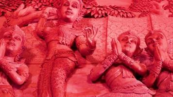 Pregando figure da parete sculture Wat Sila Ngu Tempio Rosso, Thailandia. video