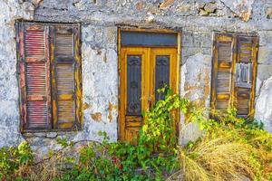 Old abandoned broken dirty houses buildings texture Rhodes Greece. photo