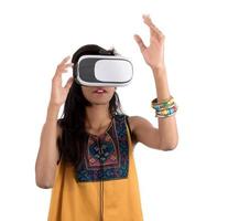 Beautiful girl looking though VR device. Young girl wearing virtual reality goggles headset. photo