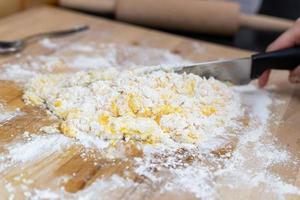 Ingredients for the preparation of homemade pasta. Eggs mixed with flour. photo