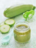 Jar with healthy baby food and zucchini photo