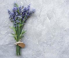 Overhead view of a bundle of fresh lavender flowers with blank tag photo