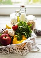 Zero waste concept. Eco bag with fruits and vegetables, glass jars with beans,  pasta. Eco-friendly shopping and cooking concept, flat lay photo