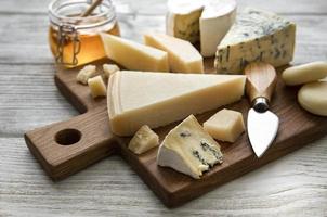 Various types of cheese  on a white wooden  background photo