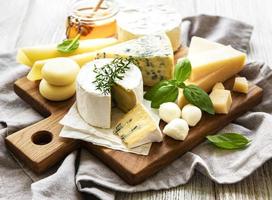 Various types of cheese  on a white wooden  background