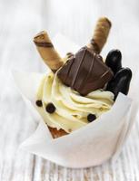 Chocolate cupcake on white wooden background