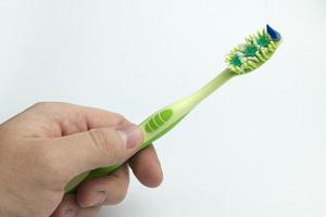 Hand holding a toothbrush. photo