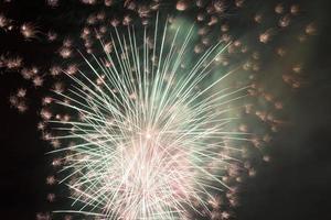 Festive, bright fireworks in the night sky. photo