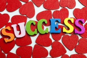 The word success is laid out on the hearts. photo