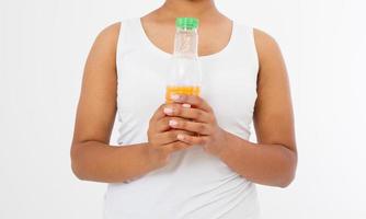 Black girl holding a bottle of juice isolated on a white background. Front view. Mock up. Copy space. Template. Blank. photo