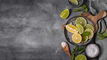 plate with lime lemon slices flat lay photo