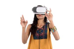 Beautiful girl looking though VR device. Young girl wearing virtual reality goggles headset. photo