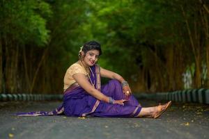 Indian Traditional Beautiful young girl in saree posing outdoors photo