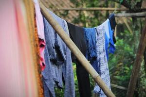 some laundry wet clothes are drying on a string