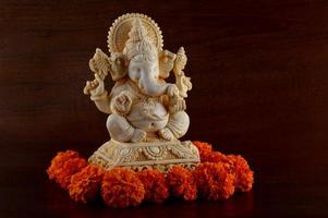 Hindu God Ganesha. Ganesha Idol on brown background photo