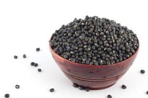 Urad dal, black gram, Vigna mungo in wooden bowl on white background photo