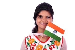 niña india de pie con bandera india o tricolor sobre fondo blanco, niña sosteniendo la bandera india, día de la independencia india, día de la república india foto