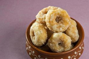 Indian Traditional Sweet Food Balushahi on a pink background photo