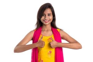 Smiling cheerful girl showing sign isolated on white background photo