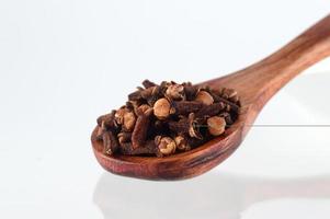 clove in spoon isolated on a white background photo