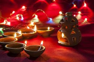 Clay diya lamps lit during Diwali Celebration. Greetings Card Design Indian Hindu Light Festival called Diwali photo