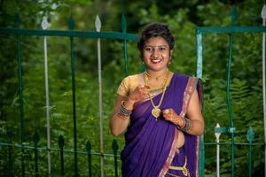 Beautiful Indian young girl in Traditional Saree posing outdoors photo