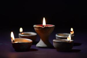 Colorful clay Diya Lantern lamps lit during Diwali celebration. Greetings Card Design Indian Hindu Light Festival called Diwali. photo