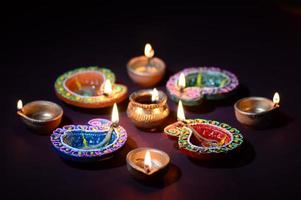Colorful clay Diya Lantern lamps lit during Diwali celebration. Greetings Card Design Indian Hindu Light Festival called Diwali. photo
