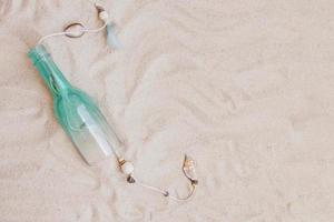 summer composition with sand bottle blank space photo