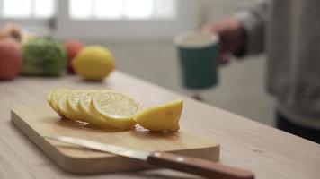 Close-up of man adding lemon to tea video