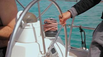 Man controls the steering wheel of a sailing boat video