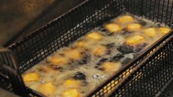 Home fries cubes fried in hot oil deep fryer video