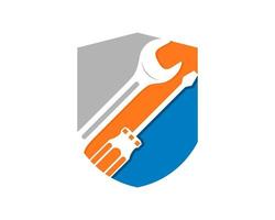 Wrench and screwdriver repair inside the shield logo vector