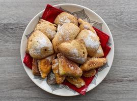 Italian sweet Tortelli di Natale with jam. Traditional italian dessert for Christmas. photo