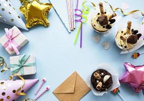 A top down view of common birthday party items in a border frame. photo