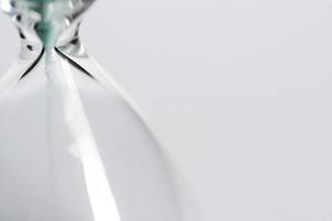 Old hourglass on white background. photo