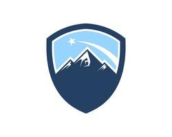 Simple shield with mountain and shooting star inside vector