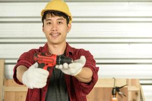 Asian young man carpenter work for customers meticulously He is a young man, a successful entrepreneur and very skilled. photo