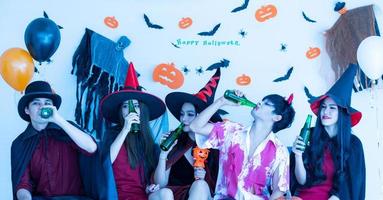 Asian young people in costumes attend celebrate at Halloween party photo