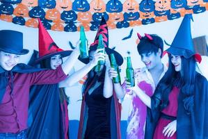 Asian young people in costumes attend celebrate at Halloween party photo