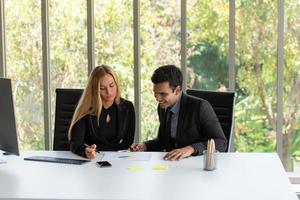 Businessmen and women analyze data and consult various issues photo