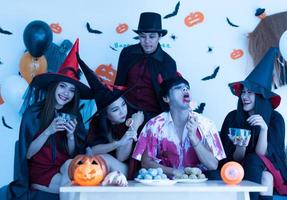 Asian young people in costumes attend celebrate at Halloween party photo