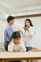 A sad girl who endured listening to her parents arguing in house. photo